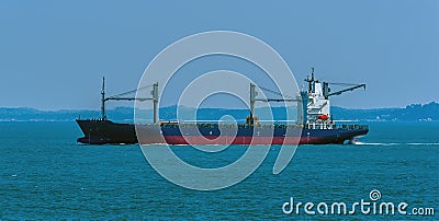 A small local freighter sailing in the Singapore Straits in Asia Stock Photo