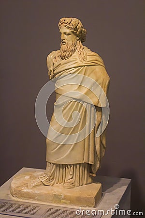 Small marble statue of god Dionysus with a wreath of ivy and pine nuts on the head Editorial Stock Photo