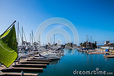 Small marina with beep blue water and many sail and power boats docked in slips. Stock Photo
