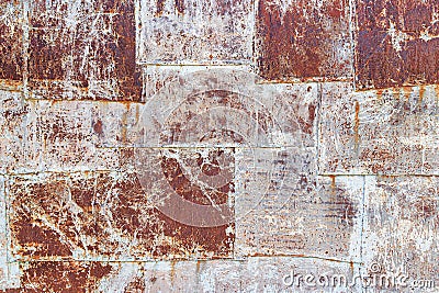 Small metal sheets stuffed on top of each other. Peeling white and beige paint. Rusty scratched iron surface Stock Photo