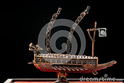 A small model of ancient Korean ironclad war ship. Korean turtle ship on a black background Stock Photo