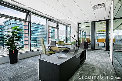 Small modern office boardroom and meeting room interior with desks, chairs and cityscape view Editorial Stock Photo