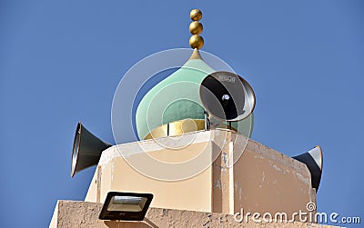 Soft Green Onion Dome with Gold Accents with Speakers for Call to Prayer Stock Photo