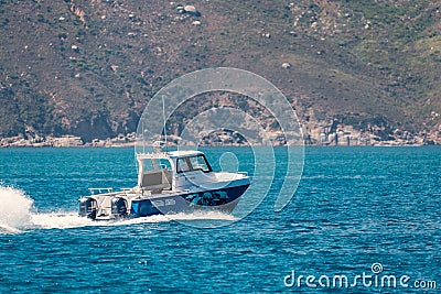 Small motorboat cruising in Hout Bay, Cape Town Editorial Stock Photo