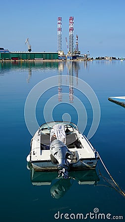 Small motorboat moored in the harbor of Croatian town Editorial Stock Photo
