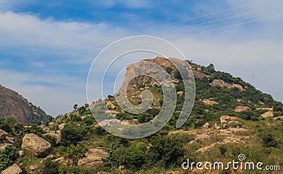 A small mountain or hill under blue sky Stock Photo