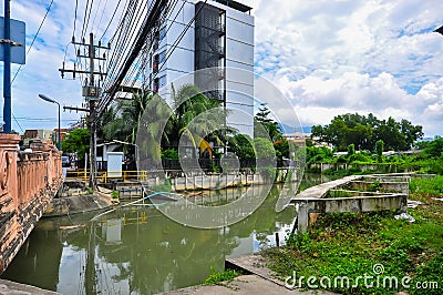 Small muddy city river in Thailand Stock Photo