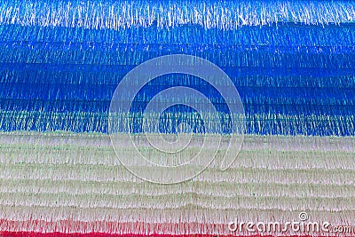 Small multi-color plastice strips hanging from the roof Stock Photo