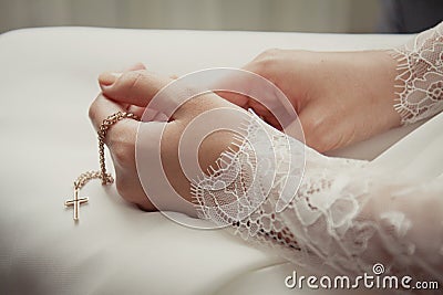 Small naive cross in the bride`s hands Stock Photo