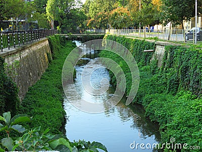 Tiny Tuchenitsa's river tributary (commonly known as Barata, literally "The Streamlet") crosses the town Stock Photo