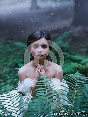 Small newborn wood elf is begging for mercy, the spirit as a symbol of fear and danger before cruel people, cute dark Stock Photo