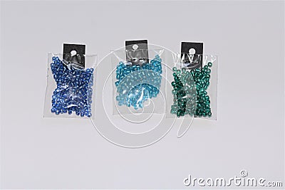 Small packs of different kind of blue colored shiny silver lined glass beads Stock Photo