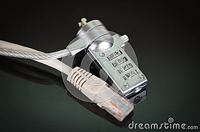 Small padlock with ethernet cable going through it, internet security concept Stock Photo