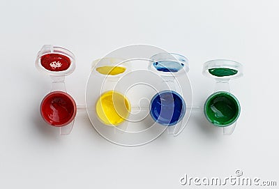 Small paint pots on white background Stock Photo
