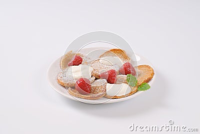 Small pancakes with cream and strawberries Stock Photo