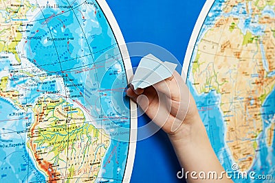 Small paper airplane on intercontinental flight to world map Stock Photo