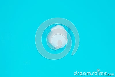 Small paper hole with torn sides over blue background for your text Stock Photo