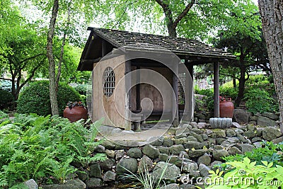 A small pavilion in a Japanese Garden filled with ferns, plants, shrubs and trees in Janesville, Wisconsin Stock Photo