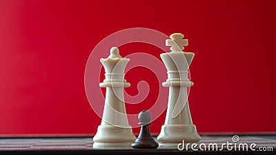 Small pawn on chess board against larger adversary concept of adversity ,discimination ,equality Stock Photo