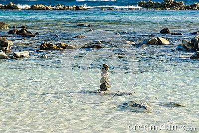 Small pebbles stacked on the sea shore Stock Photo