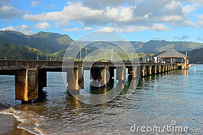 A small pier juts out into Hanalei Bay Stock Photo