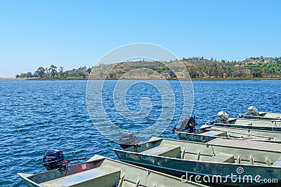 Lake with mall pier with small motor boat Editorial Stock Photo