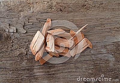 Small group of alder smoking chips for barbecuing on a wood background Stock Photo