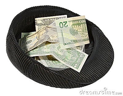 Small pile of money lies in a cap. Stock Photo