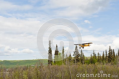 Small plane flying over Alaska Stock Photo