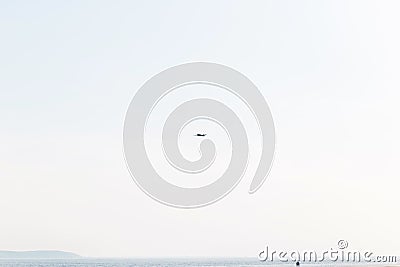 A small plane in the sky. Low-flying aircraft over the coast Stock Photo