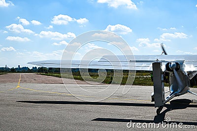 A small plane stands in the parking lot of an old airfield. Wings. Airport. Airfield. Flights by plane Stock Photo