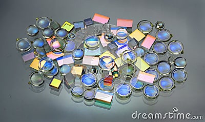 Small plastic lenses semitransparent mirrors and prisms on glass Stock Photo