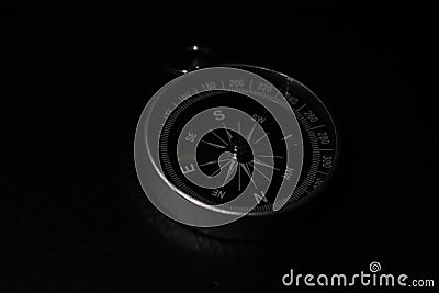 Small pocket compass on black background Stock Photo