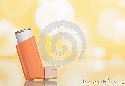 Small pocket inhaler for asthmatics, on light yellow Stock Photo