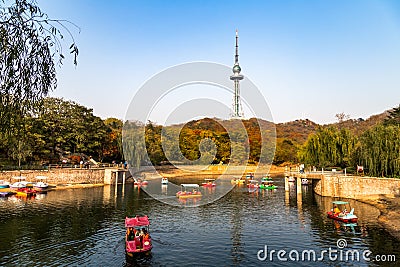 Small pond with boats in Zhongshan Park in Autumn, Qingdao, China Editorial Stock Photo