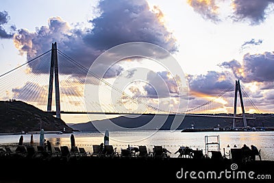 Small port with yachts and fishing boats and beach in front of Third Istanbul bridge. Stock Photo