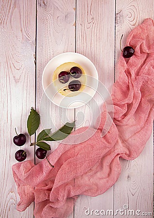 Small portion chessecake decorated with sweet cherries over on white wooden background Stock Photo