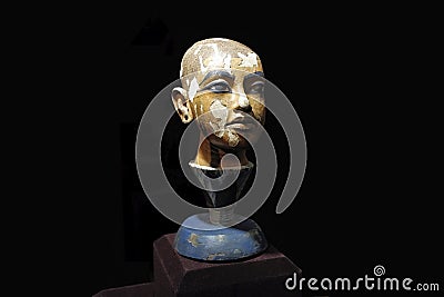 Small portrait sculpture of young pharaoh Tutenkhamun in a museum. Close up view. Editorial Stock Photo