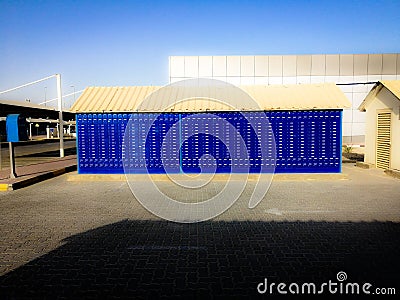 Small post office post box building with bright blue lockers Stock Photo