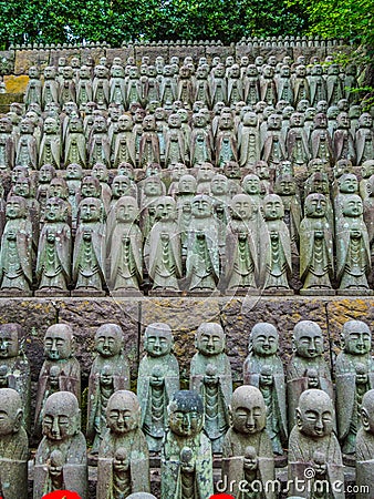 Small praying monk statues at Hase Dera Temple in Kamakura - TOKYO, JAPAN - JUNE 12, 2018 Editorial Stock Photo