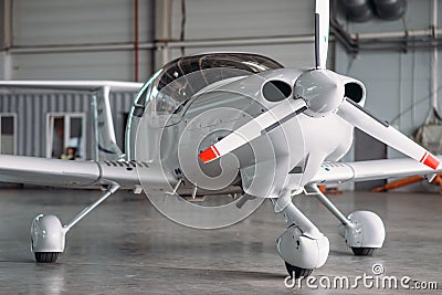 Small private turbo-propeller airplane in hangar Stock Photo
