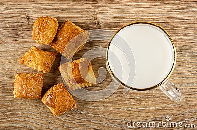 Small puff cookies, cup with milk on wooden table. Top view Stock Photo