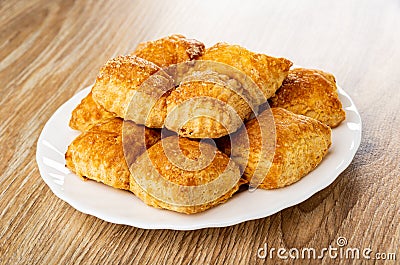 Small puff cookies in plate on wooden table Stock Photo