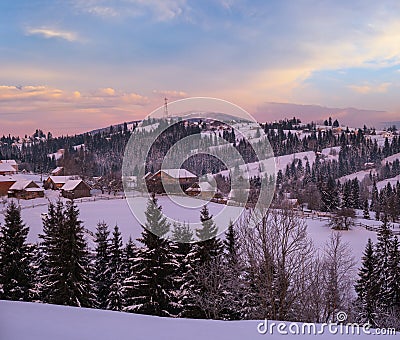 Small and quiet alpine village and winter sunrise snowy mountains around, Voronenko, Carpathian, Ukraine Stock Photo