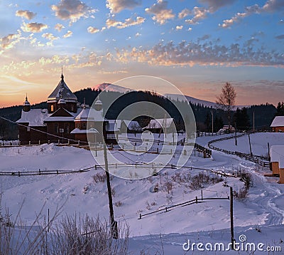 Small and quiet alpine village and winter sunrise snowy mountains around, Voronenko, Carpathian, Ukraine Stock Photo