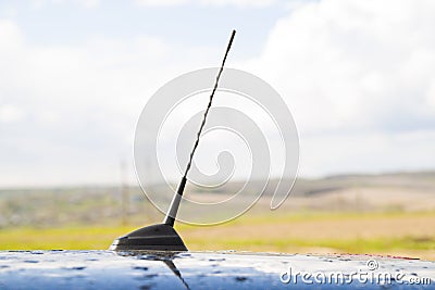 Small radio antenna on the roof of a car Stock Photo