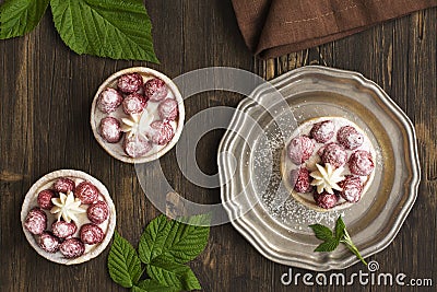 Small raspberry cheesecakes over grunge wooden table Stock Photo