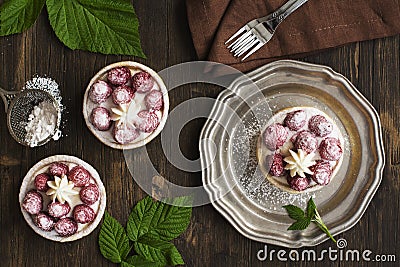 Small raspberry cheesecakes over grunge wooden table Stock Photo