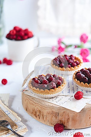 Small raspberry tarts on bright background Stock Photo