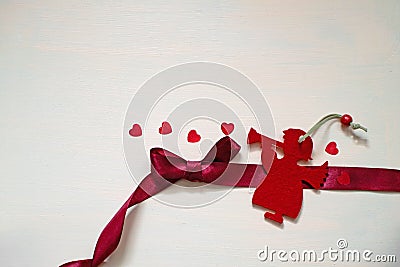 Christmas Angel play their romantic song with red heart Stock Photo